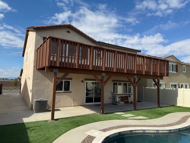 Wooden deck structure above a home in Fontana, California, showcasing quality craftsmanship and outdoor living design, with a pool and landscaped yard.