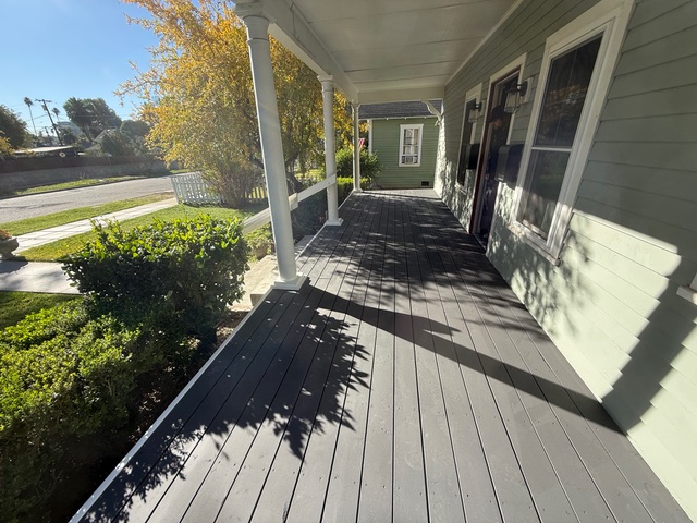 Completed gray composite front porch with white columns by BPP Construction